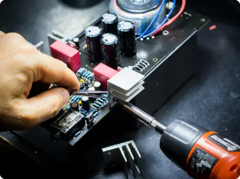 Kỹ thuật viên đang thay linh kiện trên bo mạch điện thoại